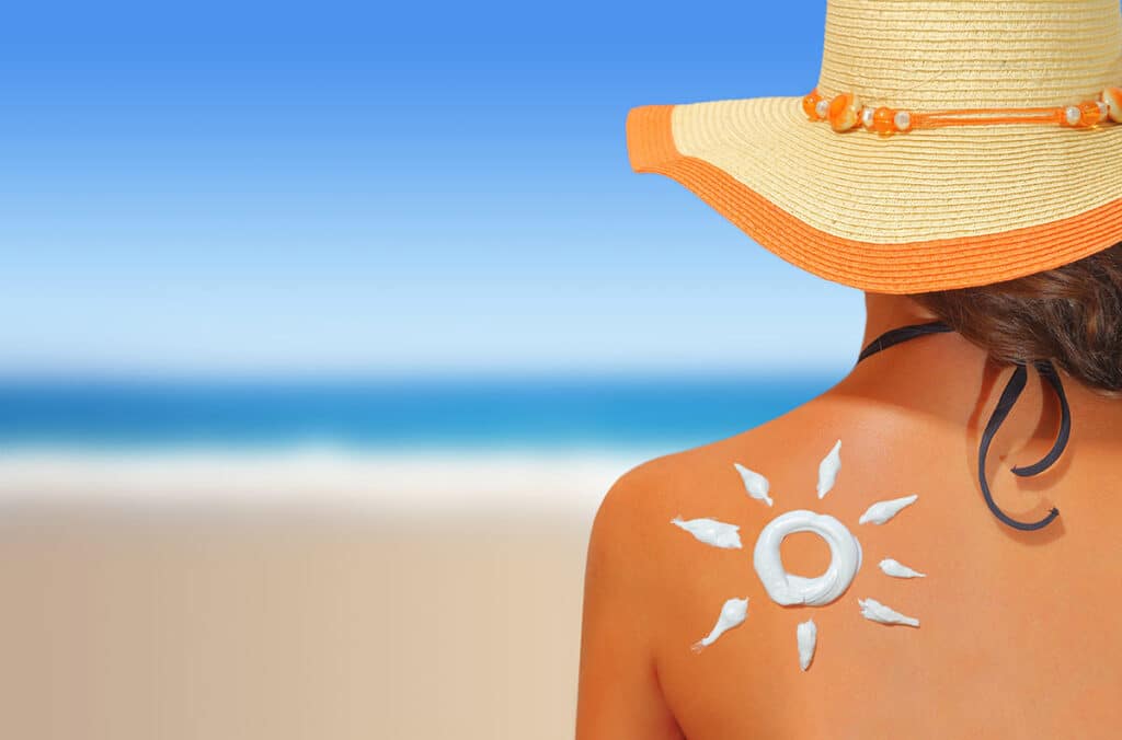 Woman with sunscreen on her back.