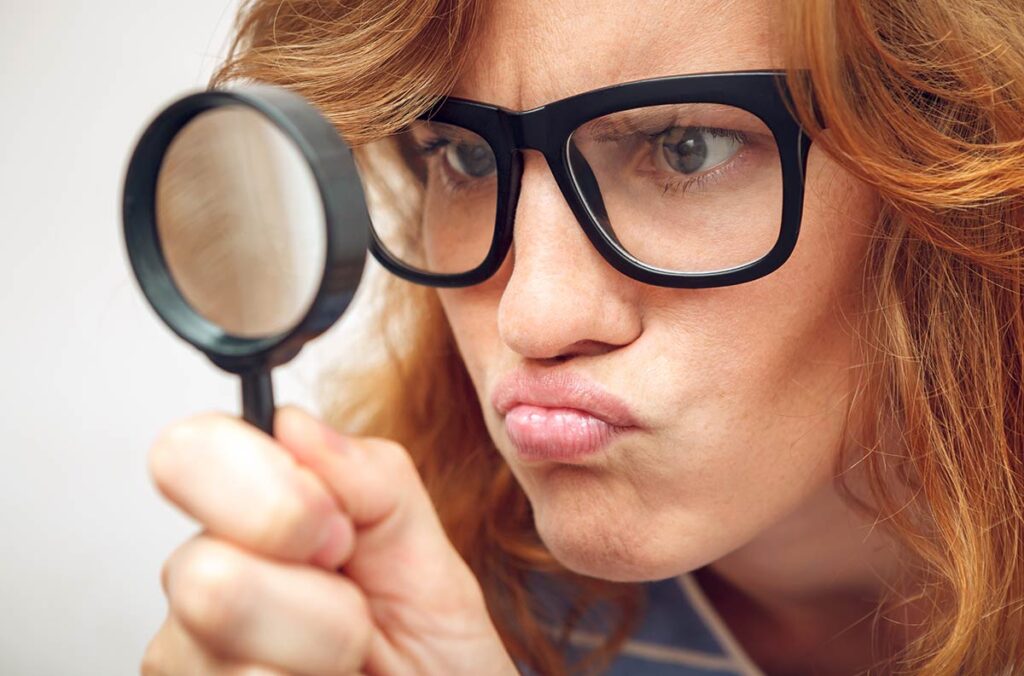 Woman with a magnifying glass.